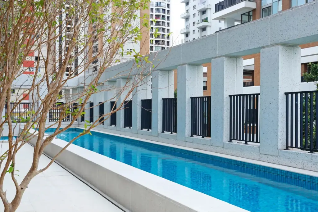 Deck da piscina com raia de 25 metros do Praça Lindenberg Itaim. Foto real